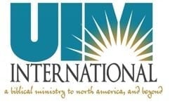 UIMI International logo with teal letters and radiating sun rays, tagline about biblical ministry to North America and beyond