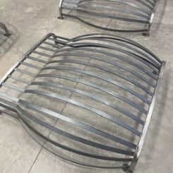 Gray striped outdoor chair cushion sitting on concrete floor