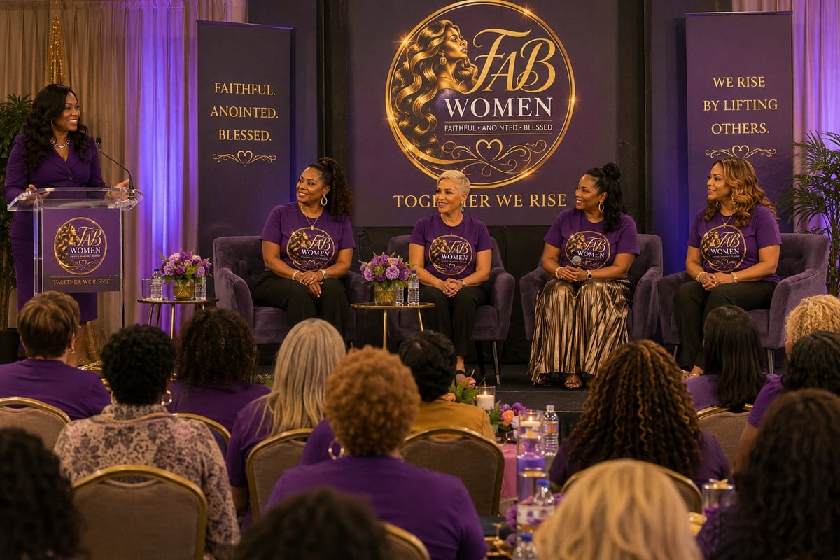 Panel of women speakers on stage at FAB Women conference event with purple lighting and audience seated in foreground