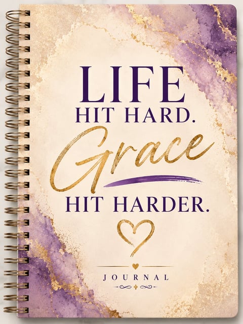 Spiral-bound journal with watercolor design featuring motivational quote Life hit hard. Grace hit harder. in purple and gold text