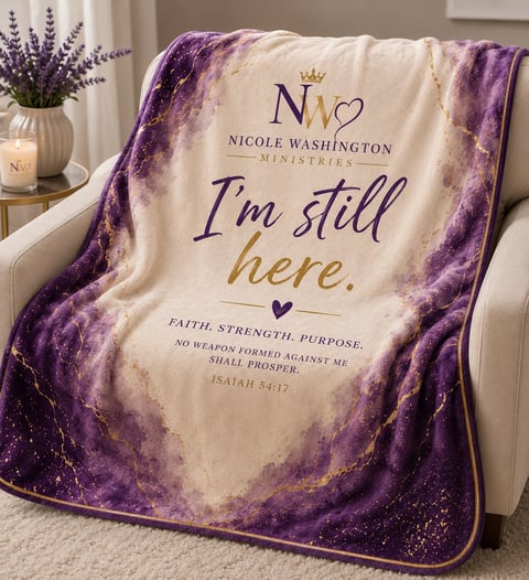 Purple and cream decorative blanket with Nicole Washington Ministries branding and inspirational text Im still here draped over a chair
