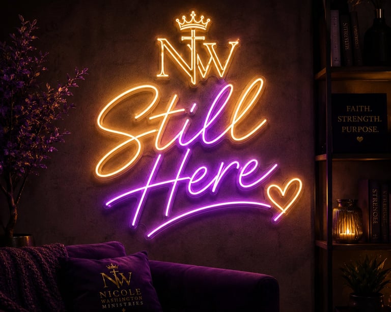 Neon sign reading Still Here in gold and purple with a crown and heart symbol on dark wall