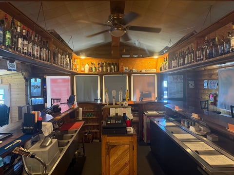 Ino Bar and Grill interior featuring memorabilia displays, wooden decor, and warm amber lighting
