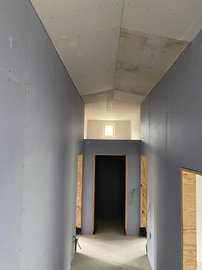 Timber stud partition corridor, boarded, with door opening.