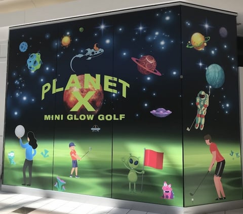 Planet X Mini Glow Golf arcade with space theme and neon green course