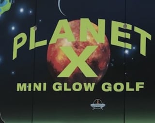 Planet X Mini Glow Golf neon sign with red planet and yellow text against starry night sky