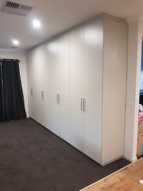 Built-in wardrobes with metal handles in a Mornington Peninsula master bedroom