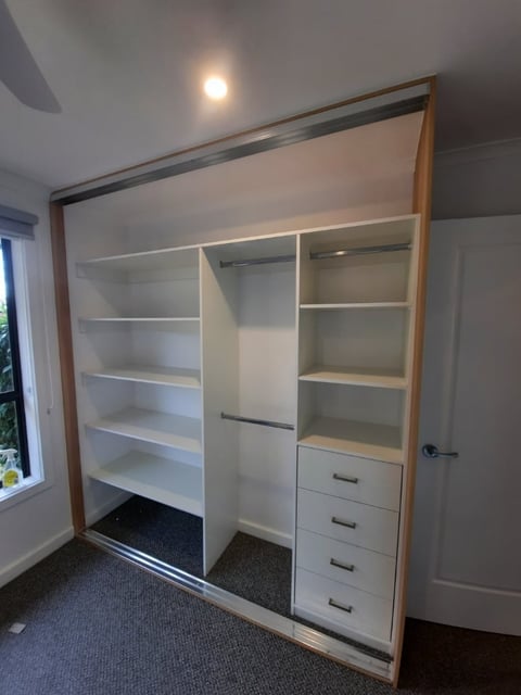 Custom walk-in wardrobe with sliding glass doors and shelving by Rod