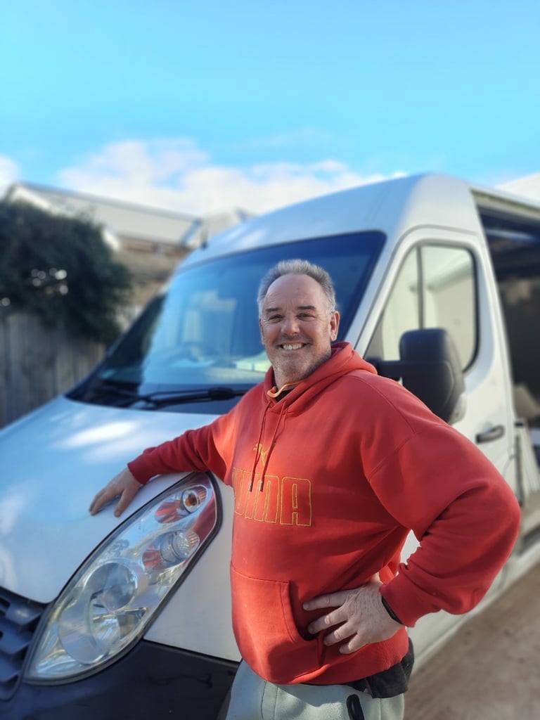Rod, owner of The Wardrobe Guy, smiling next to his work van in Mount Martha