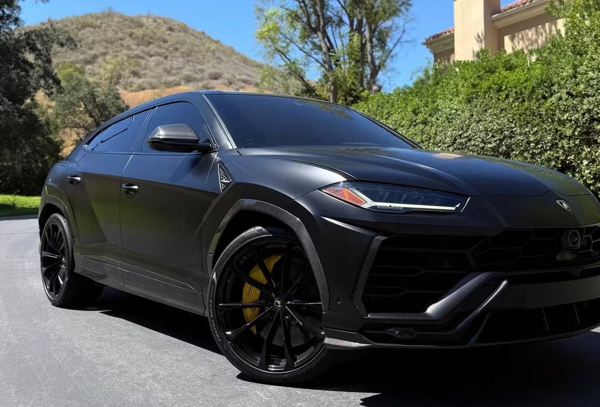 Black Lamborghini Urus with yellow brake calipers