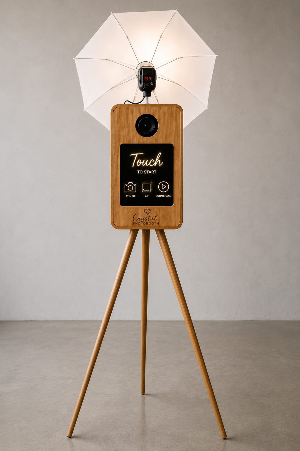 Pixelart 15.6 inch touch screen photobooth on a wooden stand with white umbrella