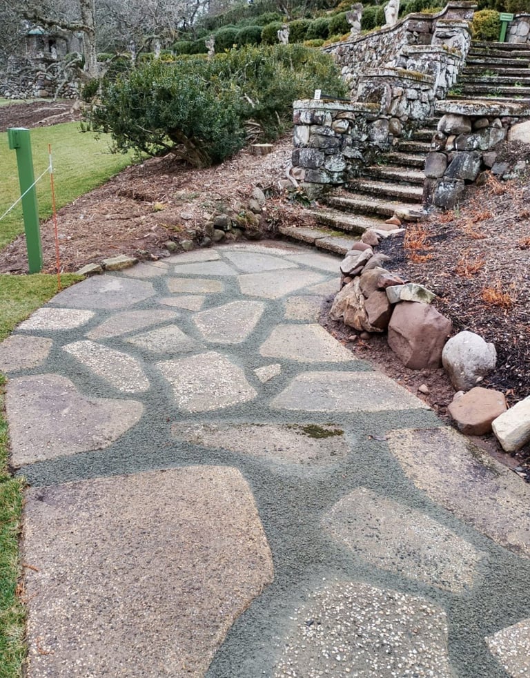 Ancient Roman mosaic floor with geometric patterns in an archaeological site with stone ruins and vegetation