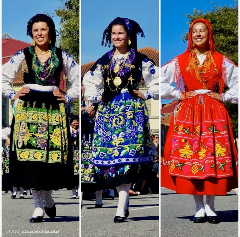 Three women wearing traditional Portuguese folk costumes with embroidered dresses, white blouses, and decorated headdresses, standing outdoors
