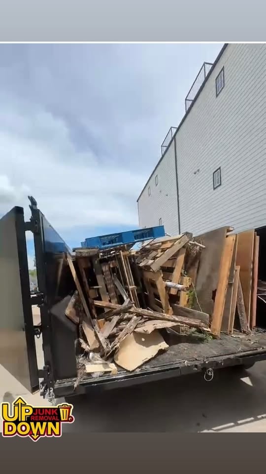 Black junk removal trailer loaded with debris