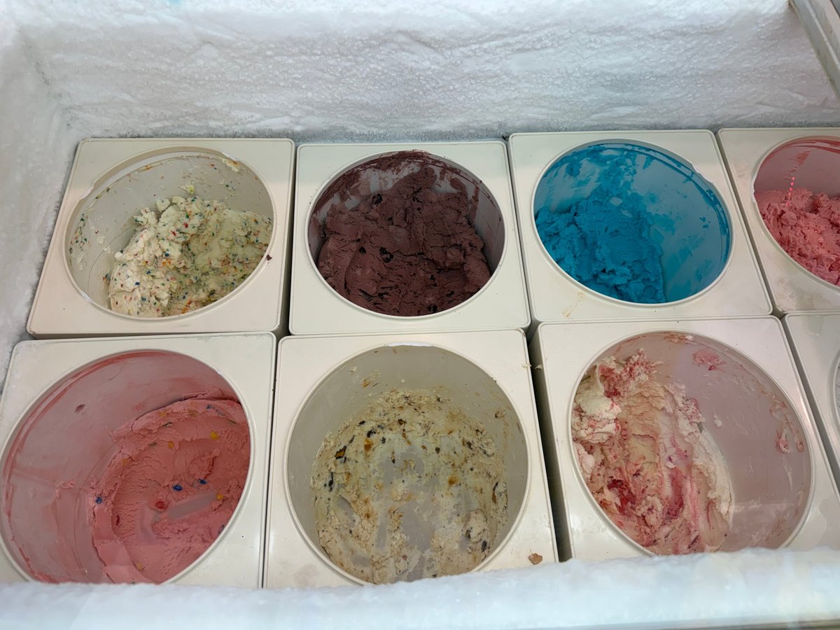 Tubs of small-batch ice cream in pink, blue, chocolate, and confetti varieties ready to scoop