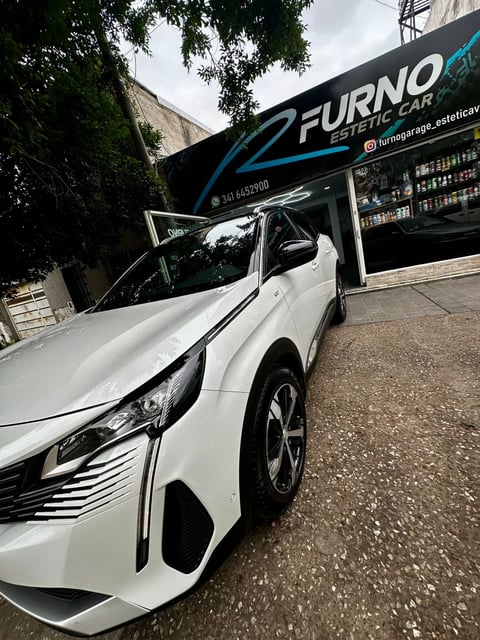 White sedan parked outside Furno auto repair garage with ivy-covered wall and storefront signage visible