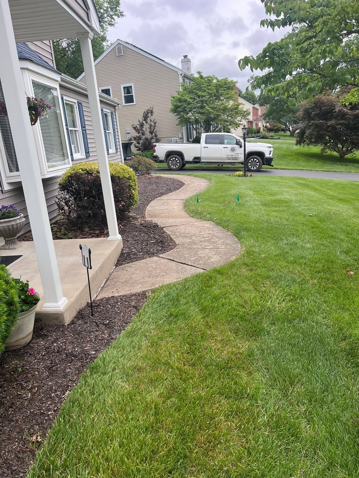 Older straight concrete walkway before replacement