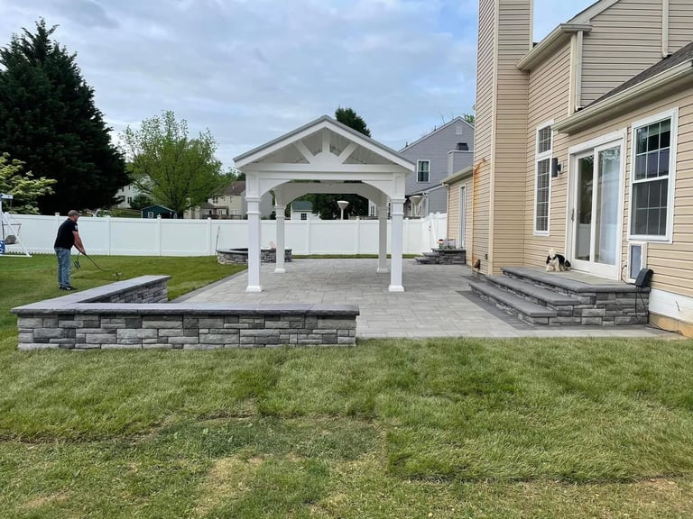 Pergola Patio & Stone Retaining Wall by Damare Landscaping