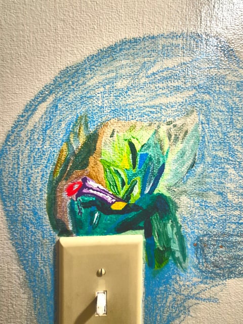 Hand-painted mural of colorful flowers and leaves drawn around a light switch plate on a textured white wall