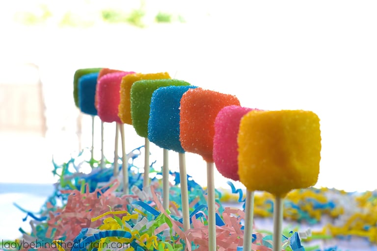 Colorful cotton candy on sticks displayed at a fairground or carnival stand