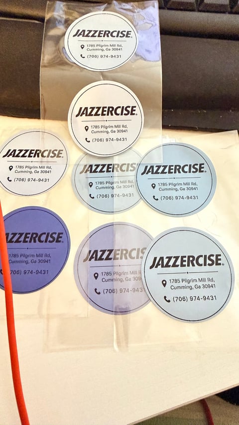 Jazzercise branded circular stickers with business address and phone number