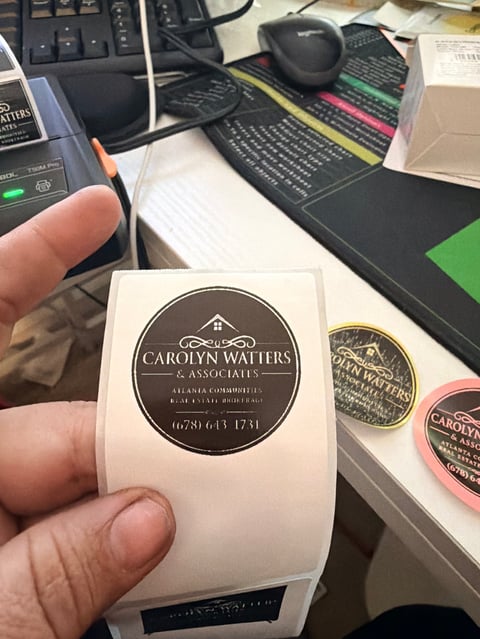 Carolyn Watters & Associates round business label with contact information
