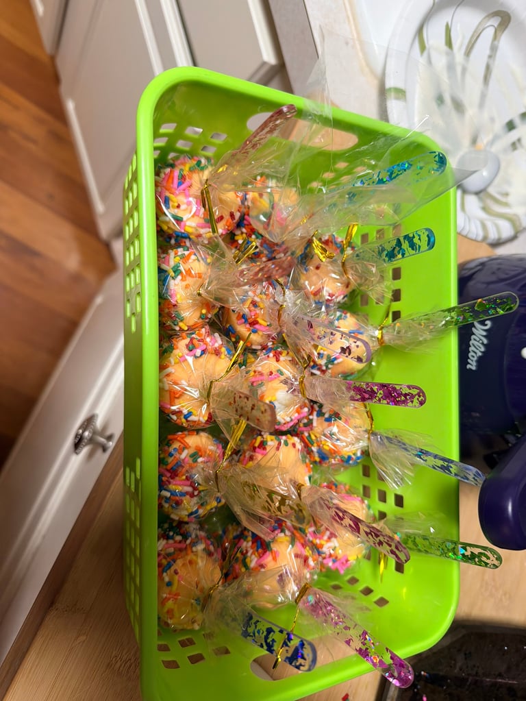 Bright green plastic crate filled with colorful wrapped candies and lollipops arranged on display