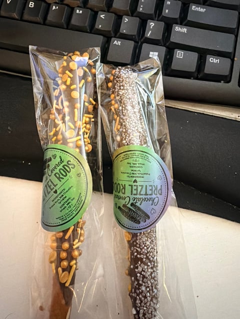 Two clear pouches of seeds with green and purple custom labels