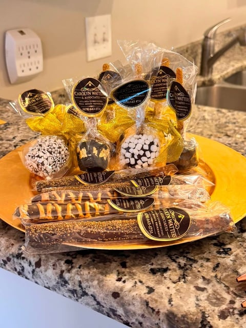 Assorted gourmet chocolates and candies displayed on a yellow plate