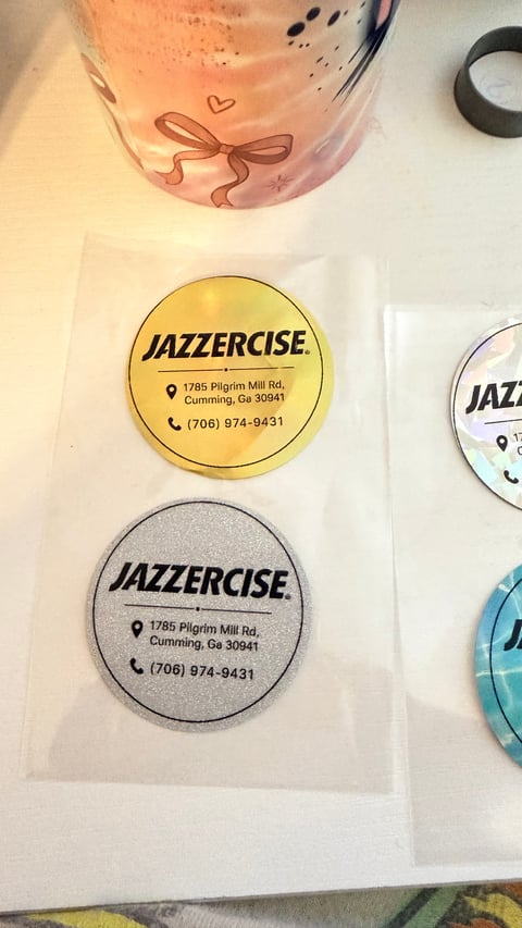 Collection of Jazzercise branded coasters in gold and silver with address and phone number