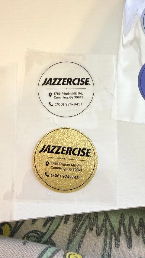 Two Jazzercise branded coasters with contact information for Cumming Georgia