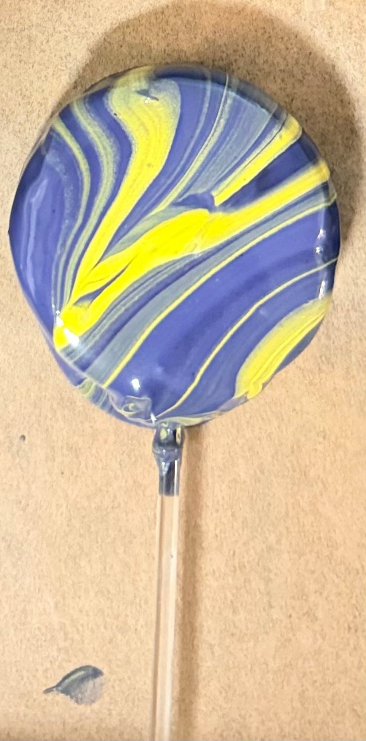 Marbled mylar balloon with blue and yellow swirled design on tan background