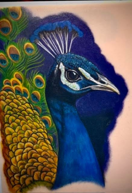 Close-up portrait of a colorful peacock with vibrant blue head, intricate feather patterns in green and gold, and distinctive eye markings