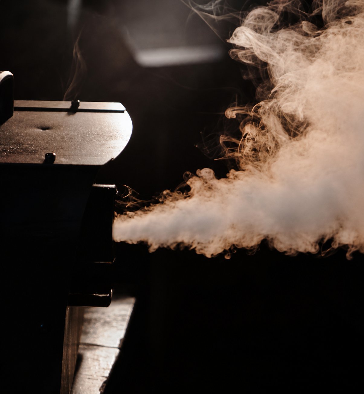 Smoke and haze effects filling a concert stage with colourful laser beams