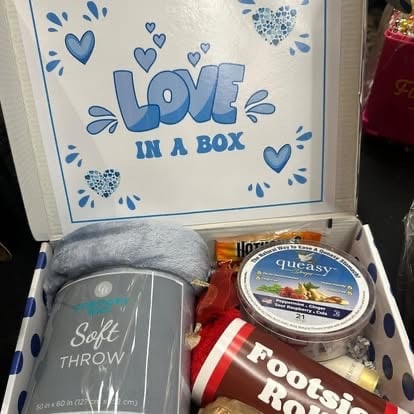 Love in a Box gift set containing a soft throw blanket, candle, and gourmet treats with decorative heart designs
