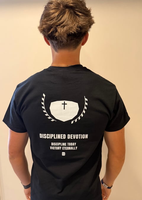 Crest back of Disciplined Devotion tee