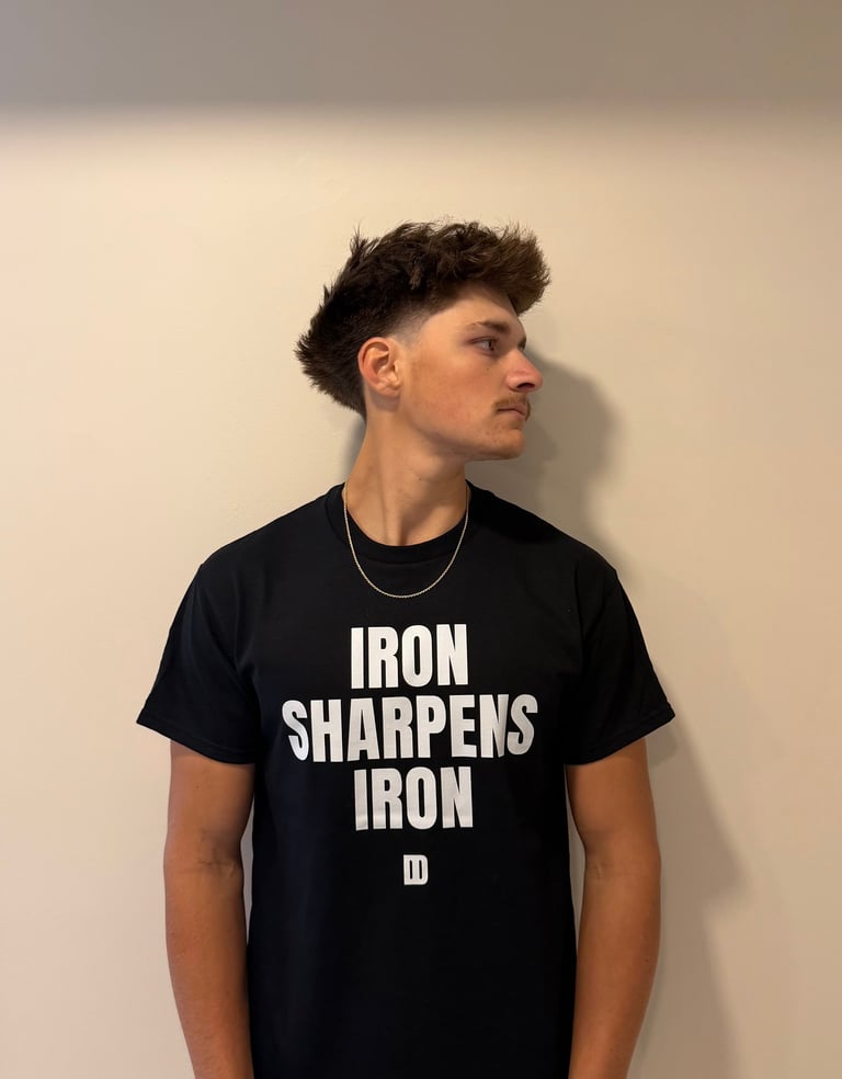 Person in profile wearing Iron Sharpens Iron black Disciplined Devotion t-shirt