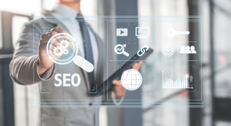 Professional touching virtual SEO interface with digital marketing icons and analytics symbols displayed on transparent screen