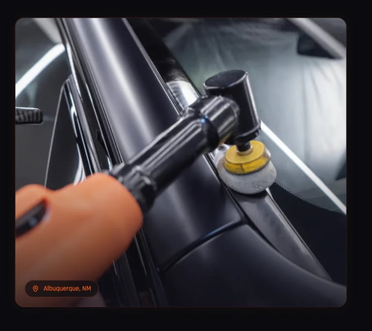 Polishing tool on a black car hood with yellow foam pad