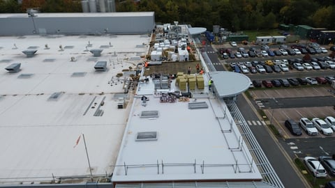 Aerial view of large warehouse rooftop with HVAC units