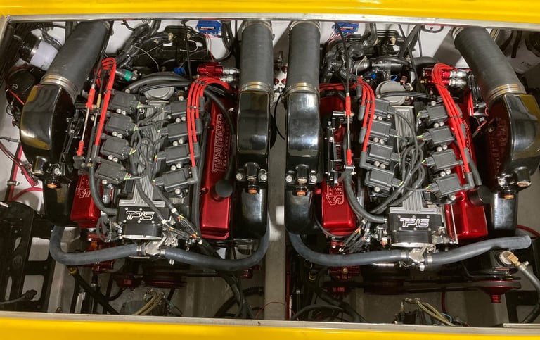 Twin custom-built 405 engines with red valve covers and black intake piping mounted side by side in the P-29 engine bay