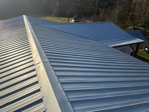 Newly installed blue metal corrugated roofing on residential building