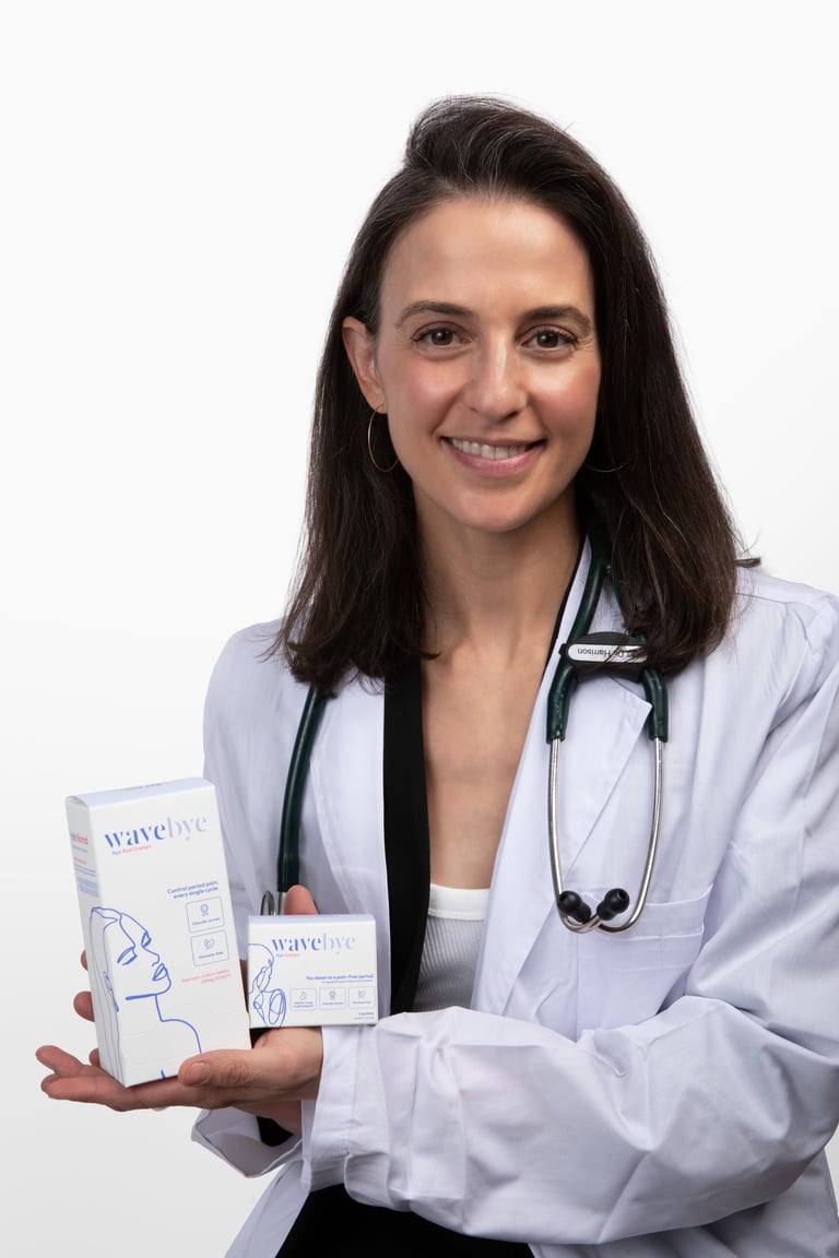 Female doctor in white coat with stethoscope holding skincare product boxes and smiling at camera