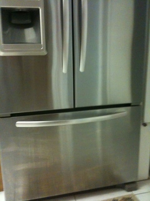 Stainless steel refrigerator with French doors, ice maker, and bottom freezer drawer