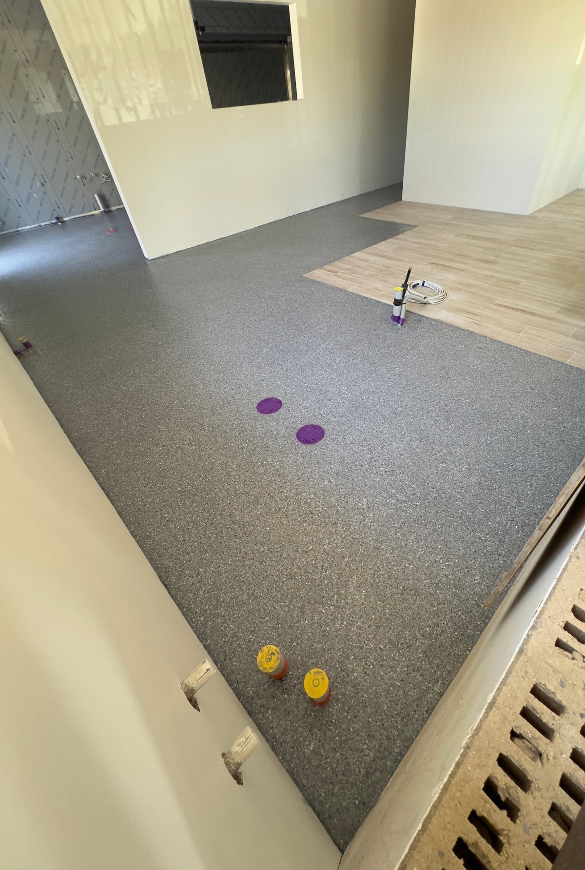 Local coffee shop with a fresh grey speckled flake floor, cream walls and timber-look entry
