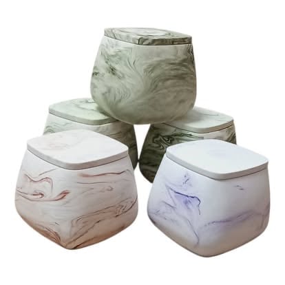 Four marbled ceramic storage containers with lids stacked in a pyramid arrangement, featuring green, pink, purple, and white colors