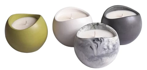 Four decorative candles in spherical containers: olive green, beige, charcoal gray, and gray with white wax visible.