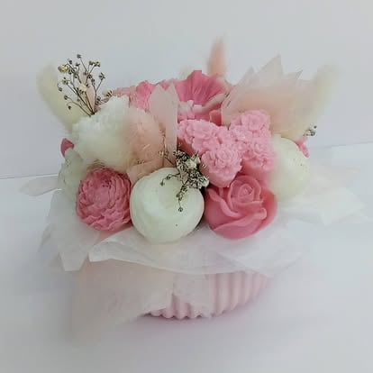 Pink and white floral bouquet arrangement with roses, carnations, and babys breath in a ribbed vase with tulle wrapping