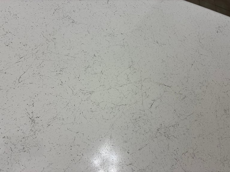 Close-up of a light gray speckled countertop surface ready for clear coat refinishing