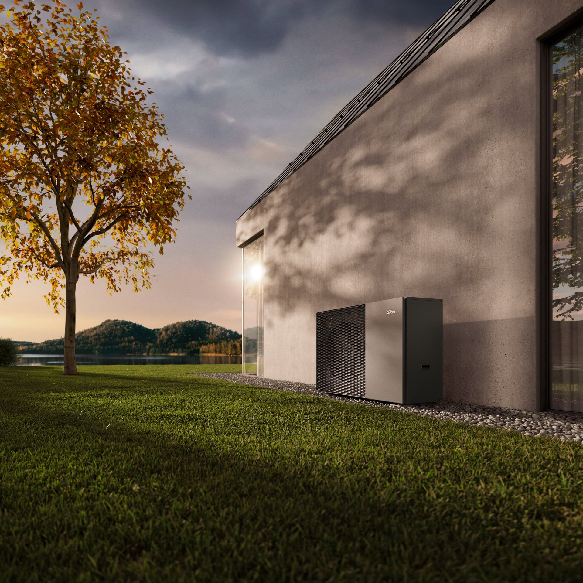 Modern white building with large windows on manicured lawn beside a golden tree overlooking a lake at dusk